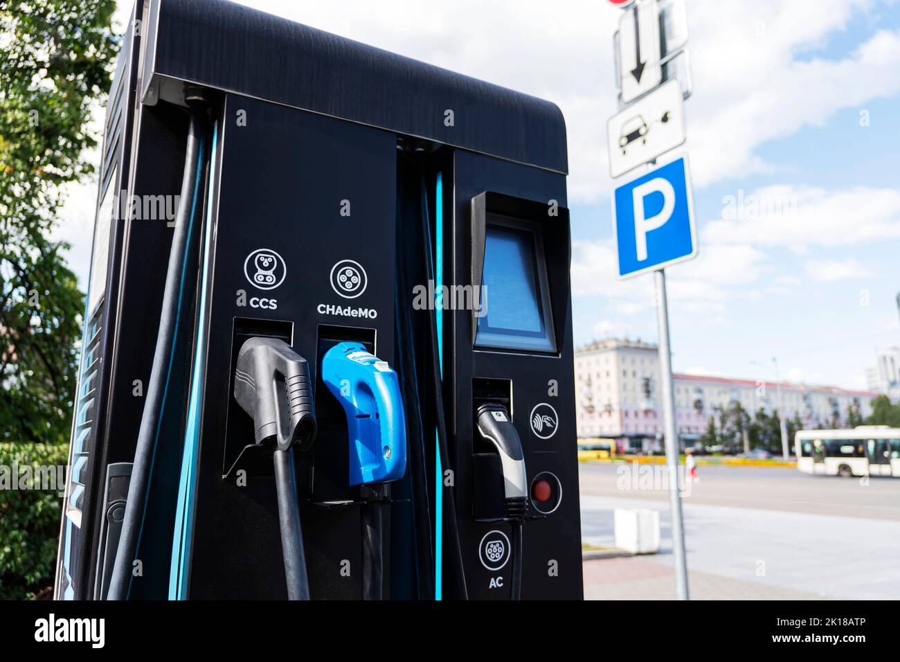 an electric car battery charging station on a city street. A modern gas station with electricity. Stock Photo