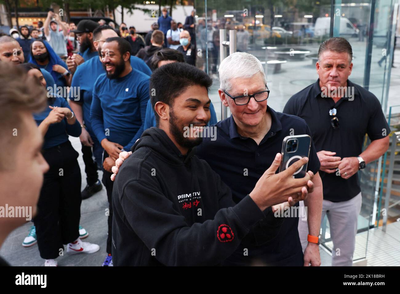 Apple CEO Tim Cook takes a selfie with a customer as they enter the Apple Fifth Avenue store for the release of the Apple iPhone 14 range in Manhattan, New York City, U.S., September 16, 2022.  REUTERS/Andrew Kelly Stock Photo