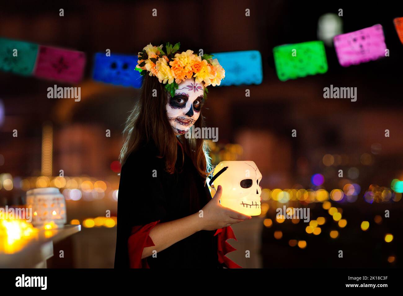 Dia de los muertos celebration. Traditional Day of the Dead party. Halloween in Mexico. Mexican girl in traditional make up and Catrina costume Stock Photo