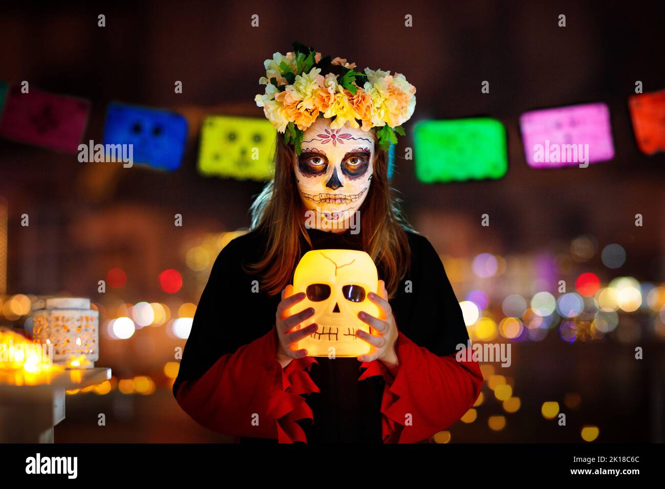 Dia de los muertos celebration. Traditional Day of the Dead party. Halloween in Mexico. Mexican girl in traditional make up and Catrina costume with a Stock Photo