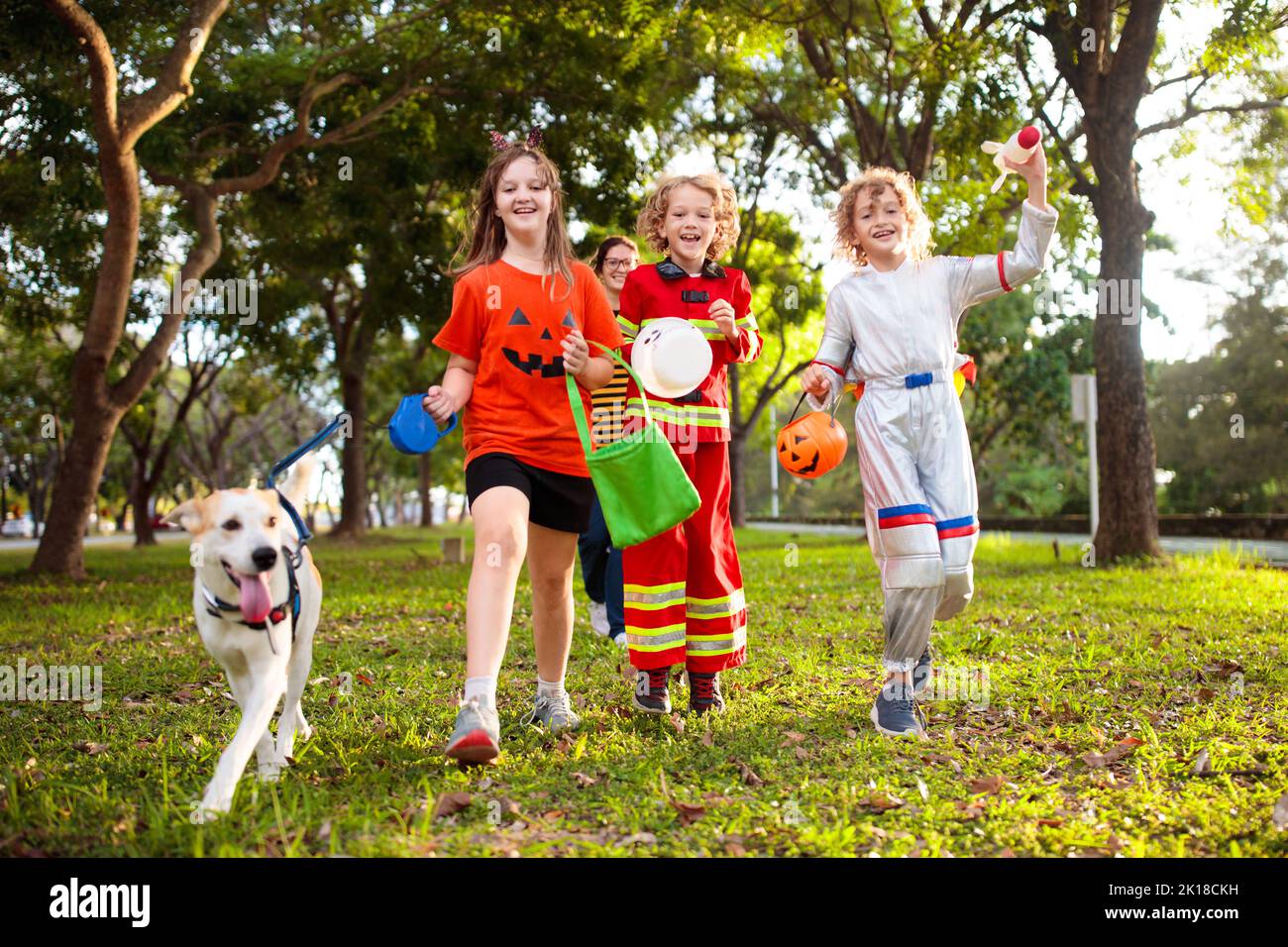 Kids trick or treat in Halloween costume. Children in colorful dress up