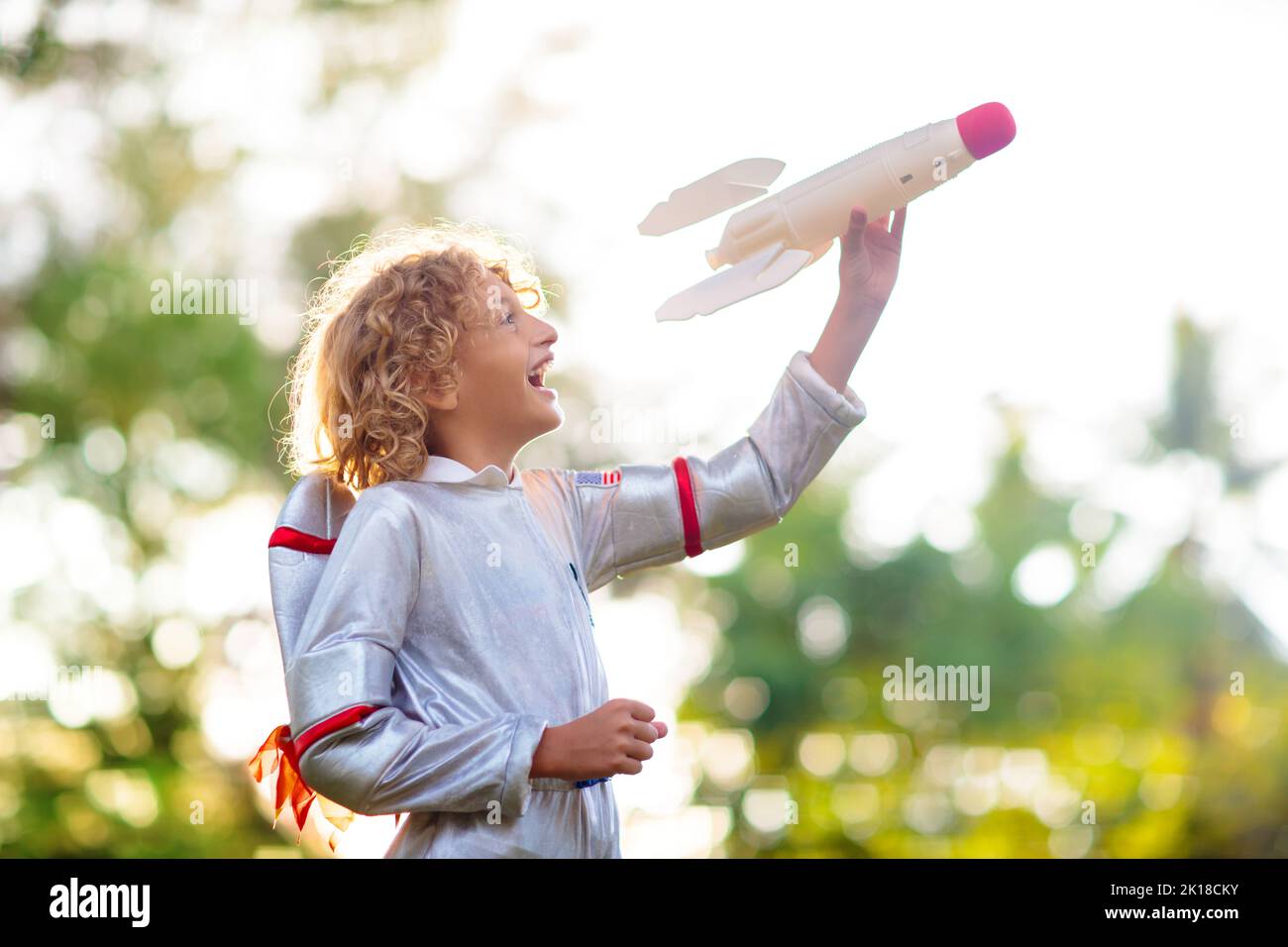 Little boy playing with spaceship. Astronaut costume for Halloween party. Creative child with space rocket. Kids dream and imagine. Role play for chil Stock Photo