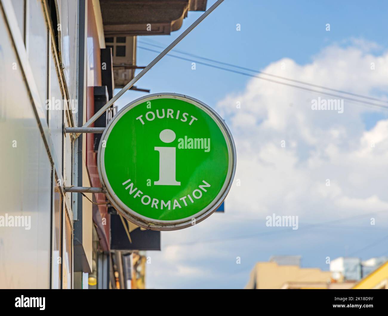 Tourist Information Illuminated Round Green Sign in Town Stock Photo