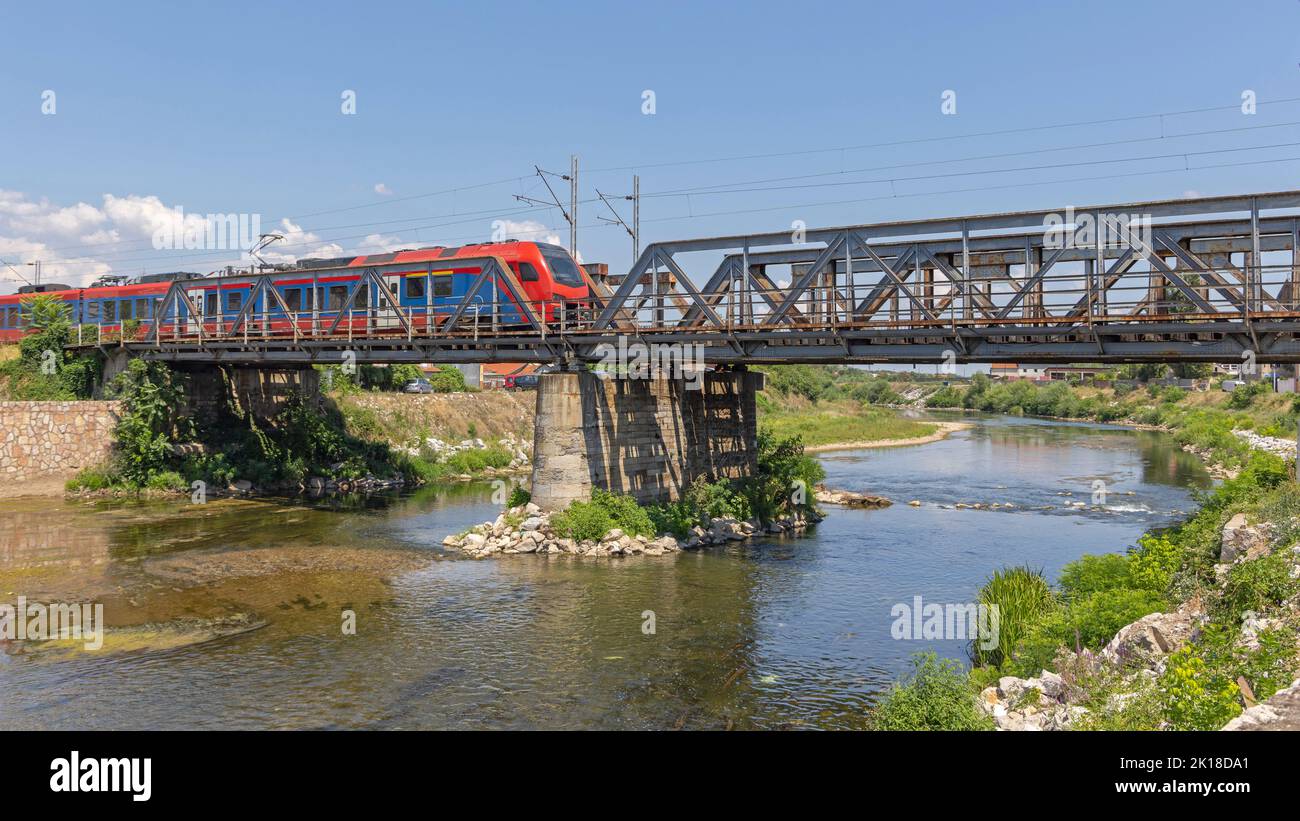 Urban Transport Train at Bridge Over River Summer Day Stock Photo