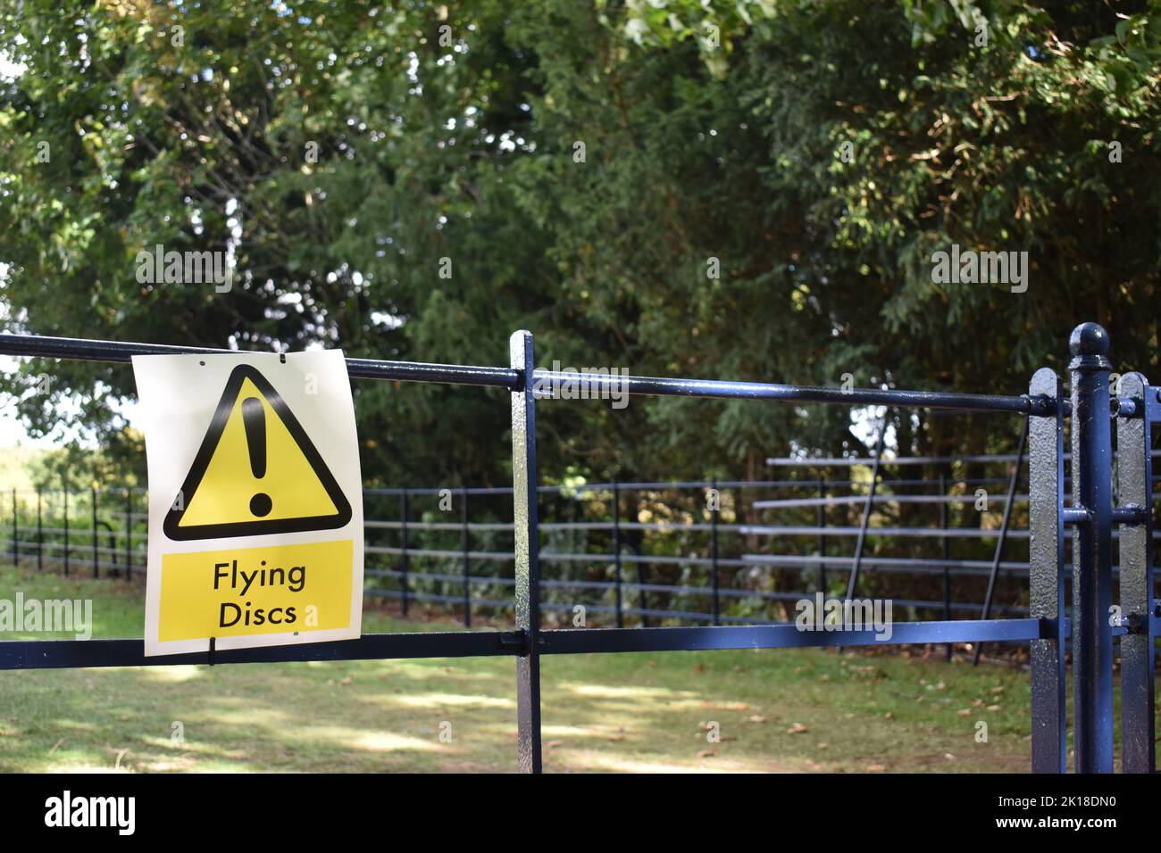 A sign on a fence in Campbell Park, Milton Keynes: 'Flying Discs'. This refers to disc golf which is played in the park. Stock Photo