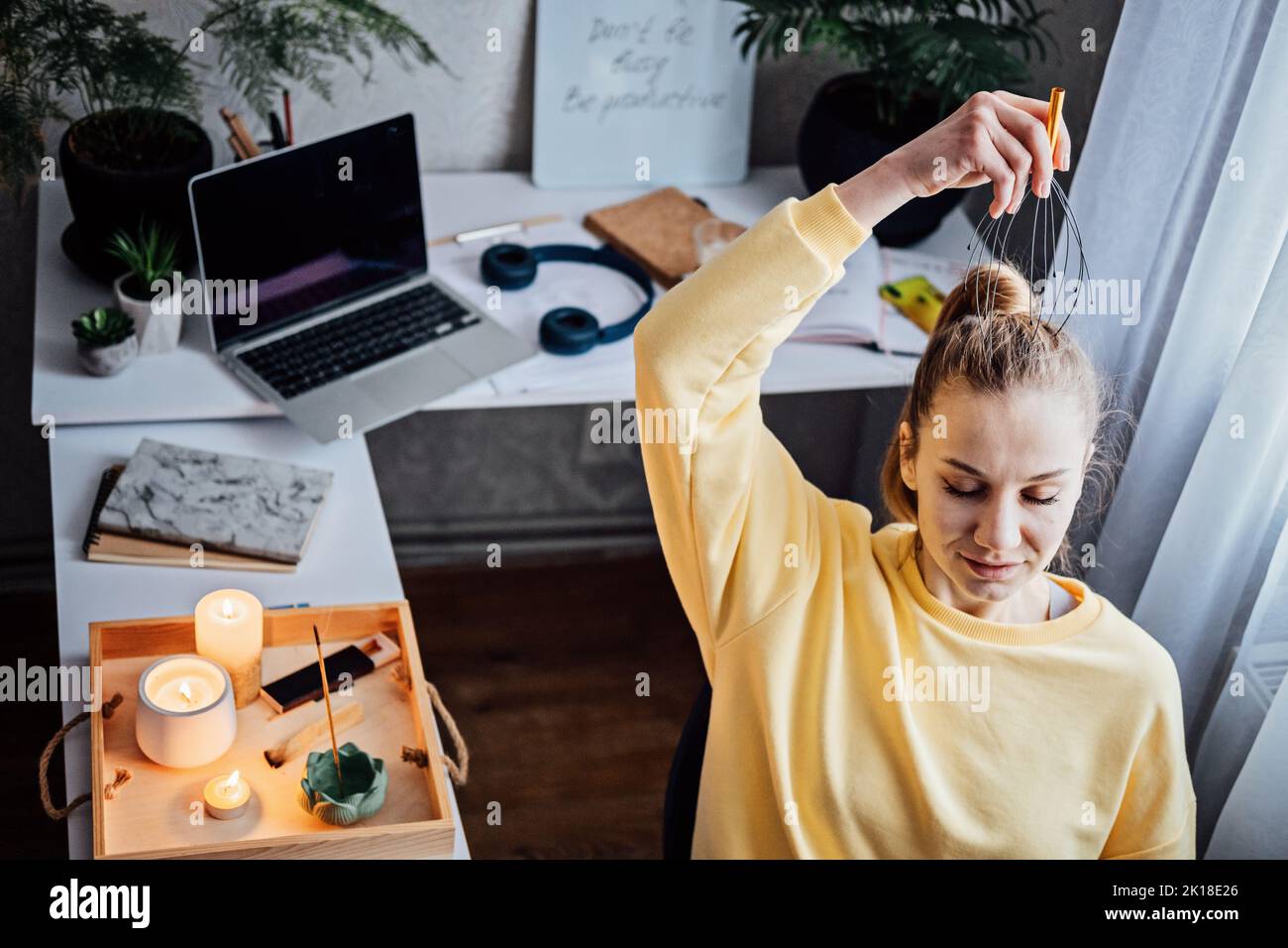 Woman on workplace with Head Massager Scalp Scratcher with Fingers
