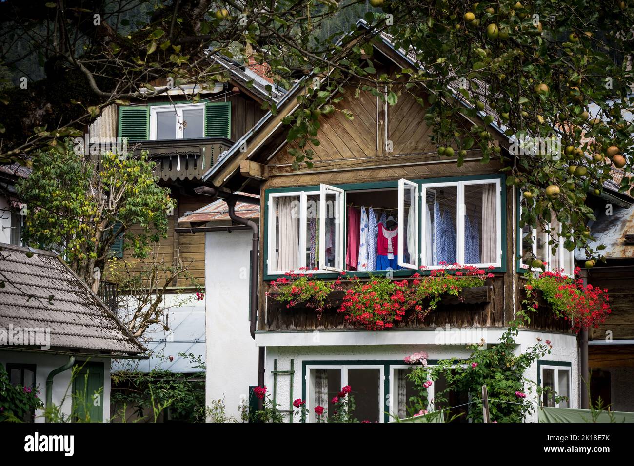 View of a typical historic townhouse in the center of Altaussee, Ausseer Land, Styria, Austria, with a traditional dirndl dress hung out to dry Stock Photo