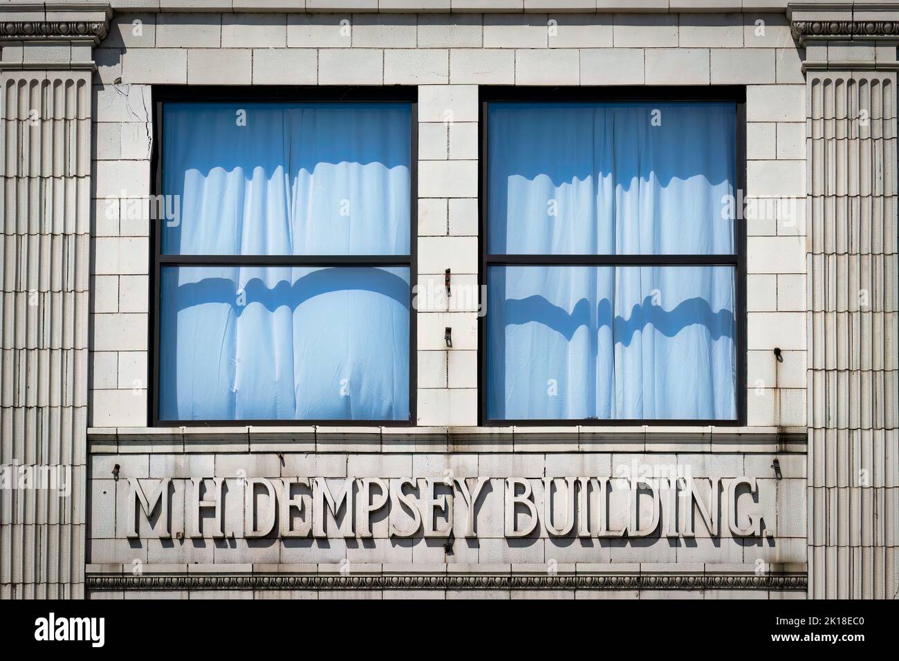 The tinted windows of the Dempsey building, constructed around 1910 in the neoclassical style by Michael H. Dempsey, a local business man in Manitowoc Stock Photo