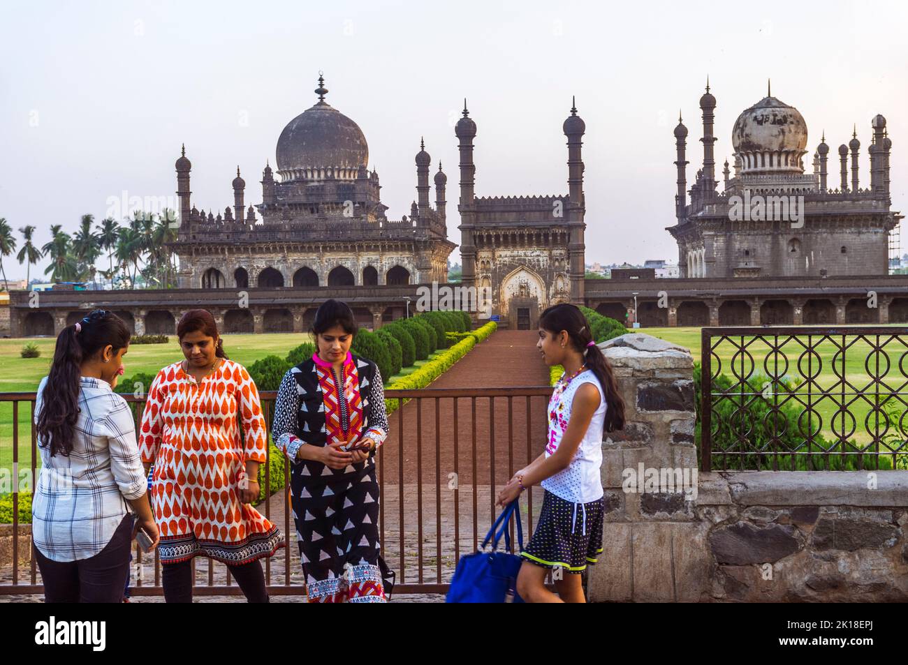 Bijapur, Karnataka, India : A group of young women stand next to the 17th century Ibrahim Rouza mausoleum and mosque considered as one of the most bea Stock Photo