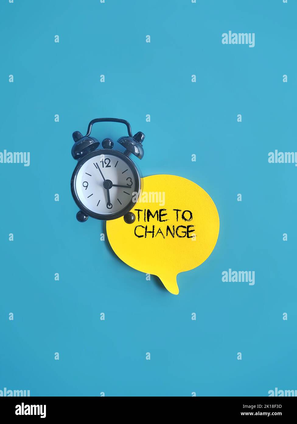 Top view image of clock and speech bubble with text TIME TO CHANGE. Motivation, inspiration concept Stock Photo