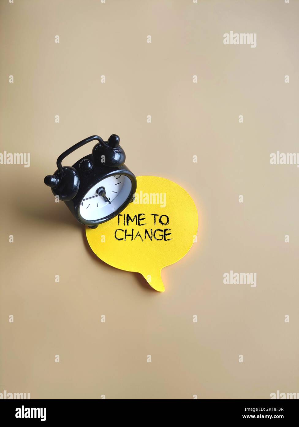 Top view image of clock and speech bubble with text TIME TO CHANGE. Motivation, inspiration concept Stock Photo