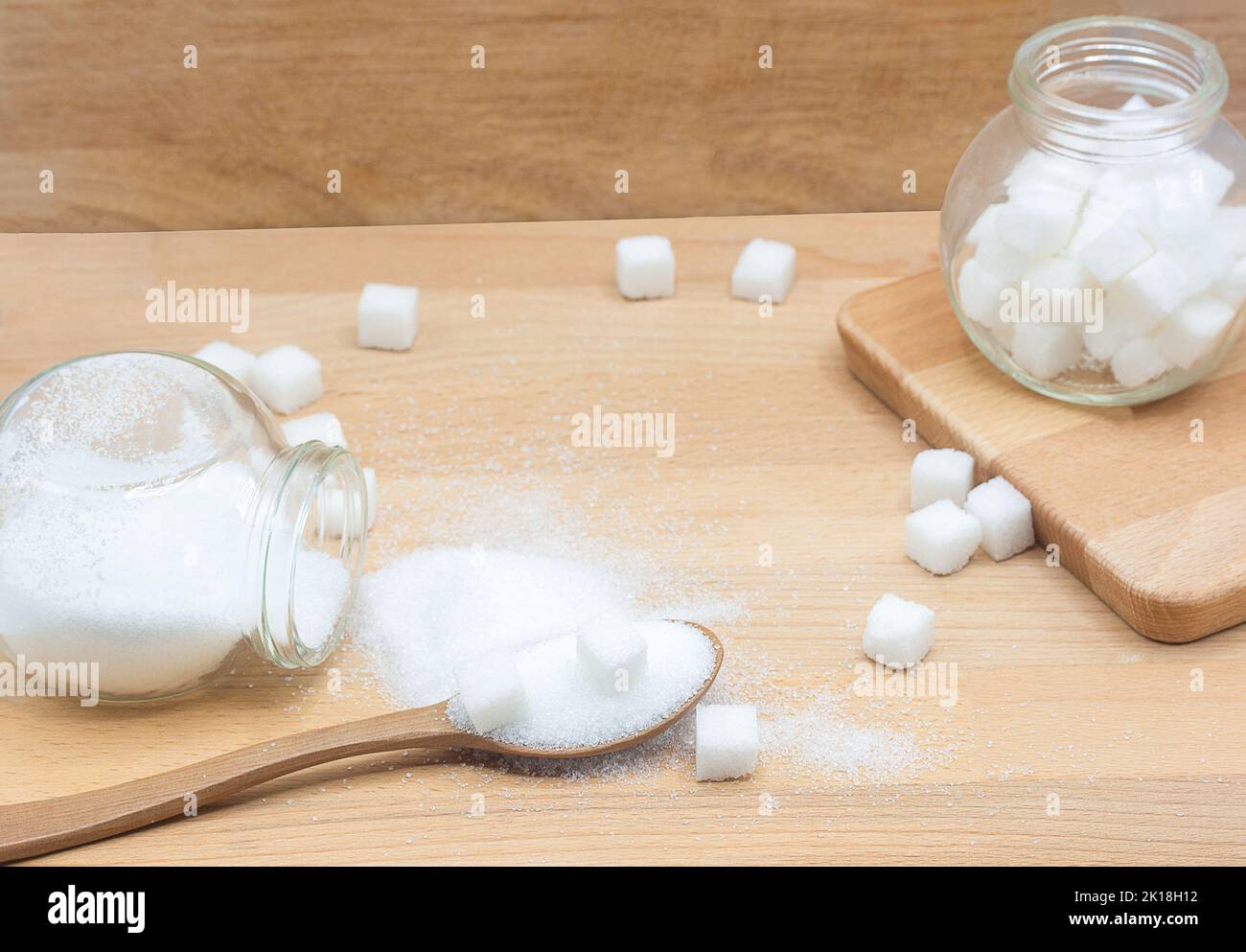 white sugar and sugar cubes in wood spoon on wooden background with copy space Stock Photo