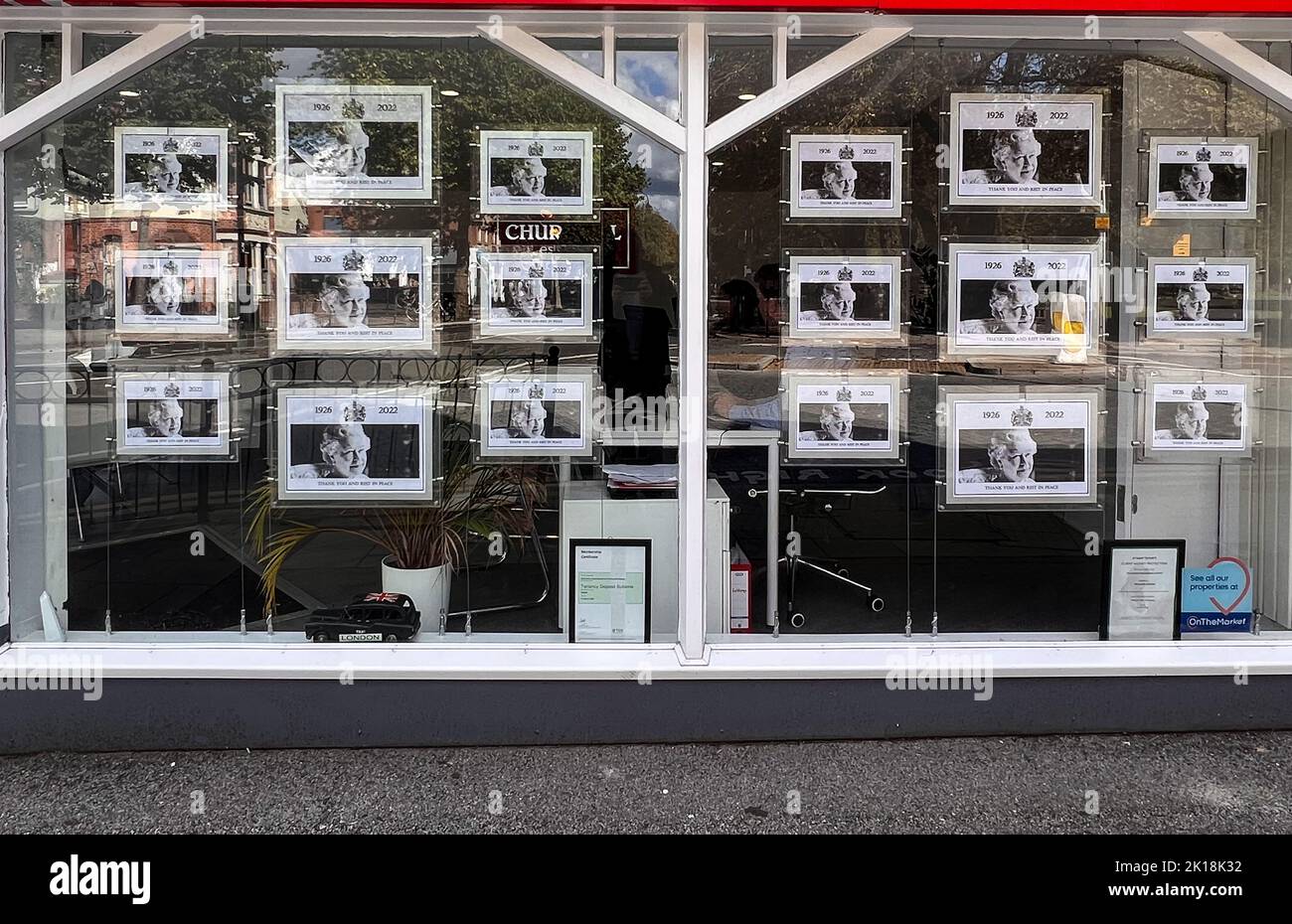Estate agents windows in Wanstead , East London display photographs of the Queen in memory of her passing.  -September 16, 2022 Stock Photo