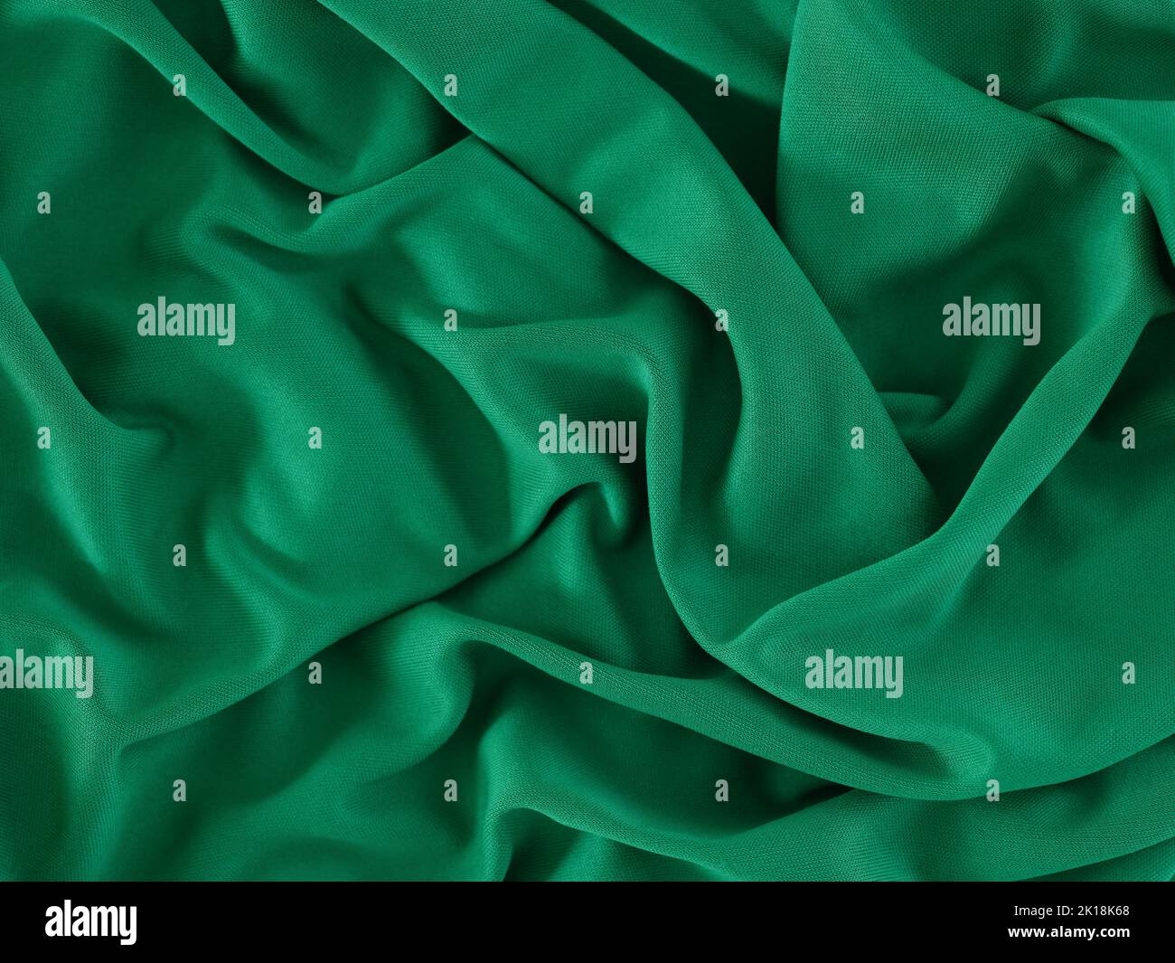 A crumpled green fabric background. Close up. Stock Photo