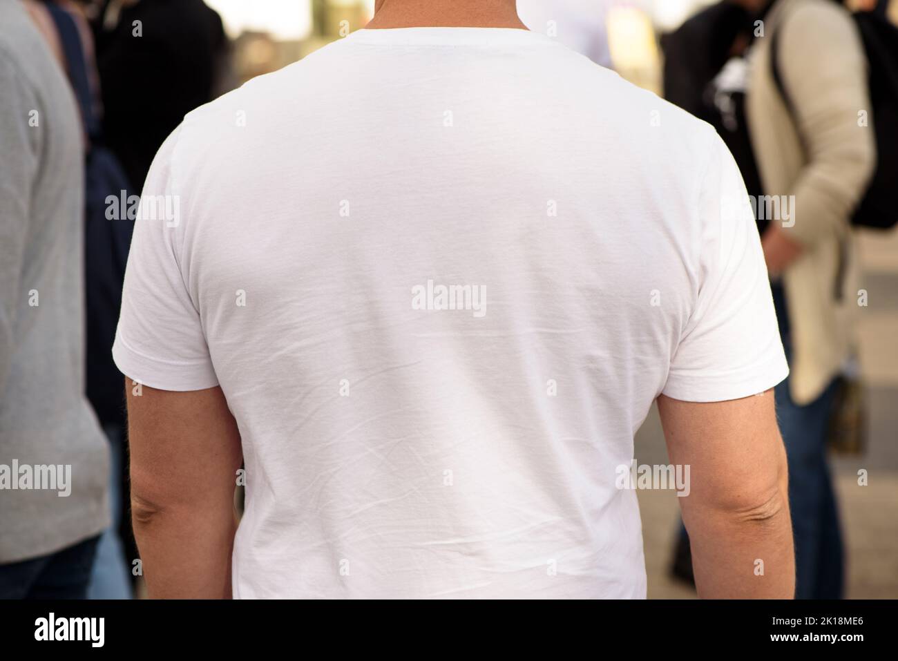 Unrecognizable man dressed white t-shirt. Template for your design. Rear view. Closeup Stock Photo