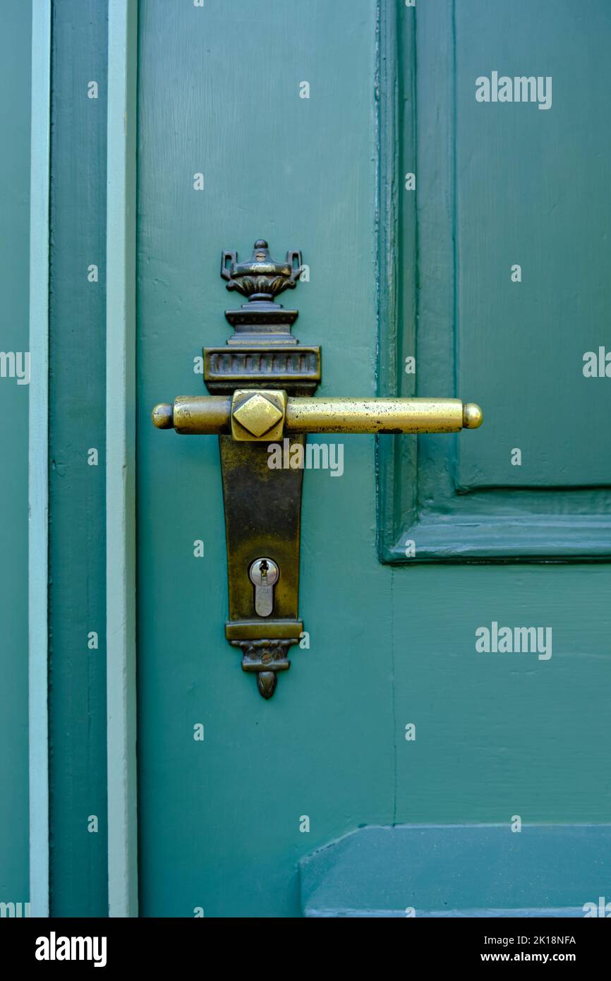 Old vintage door handle on a green door Stock Photo Alamy