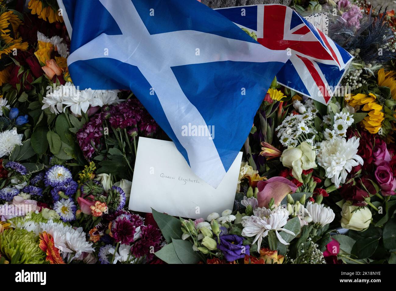 Flowers, flags and letters left in the gardens of Palace of Holyroodhouse as a mark of respect to Her Majesty Queen Elizabeth II, who has died aged 96yrs, in Edinburgh, Scotland, 13 September 2022. Stock Photo