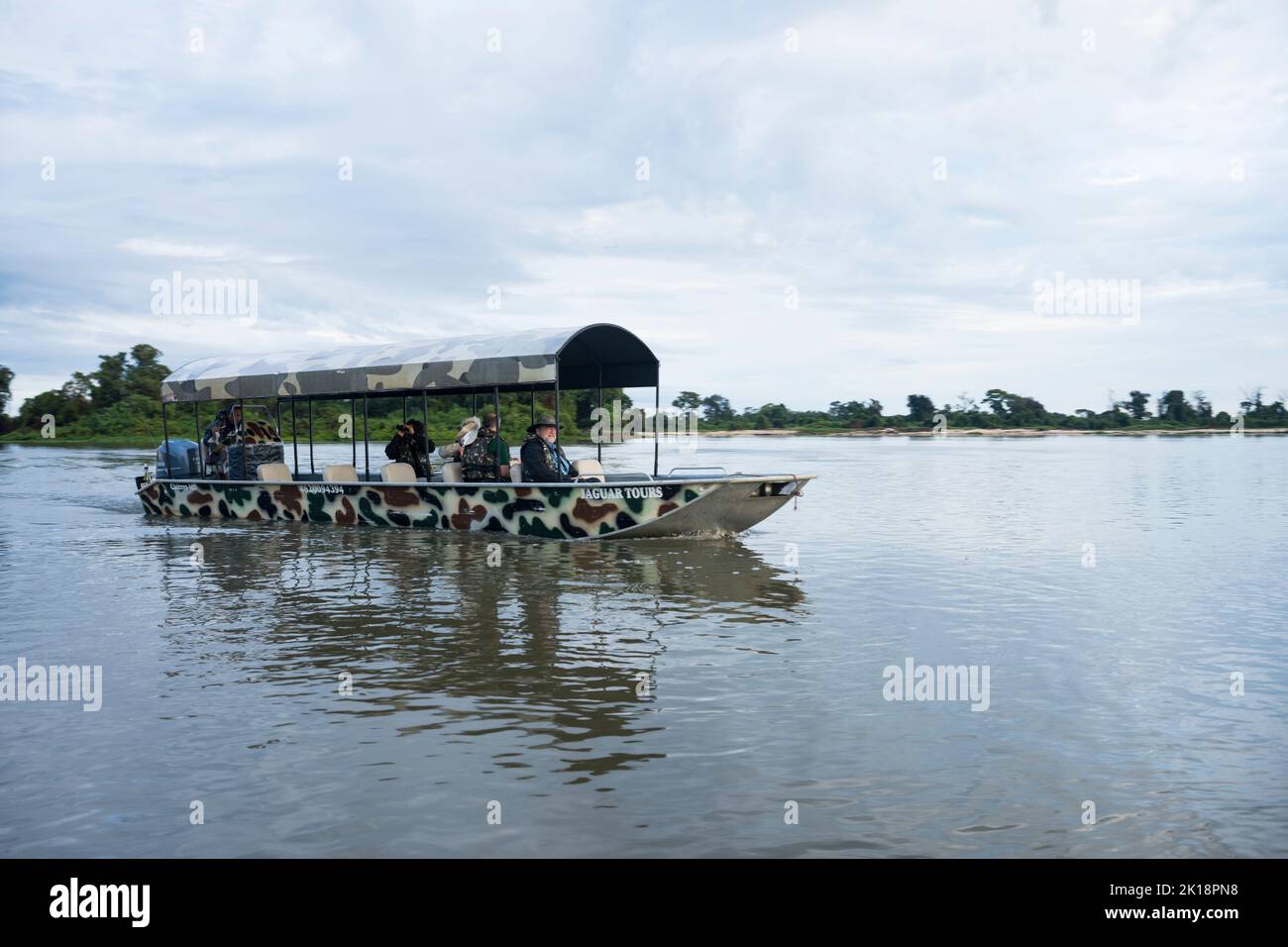 An excursion boat with tourists on the Paraguay River near Baiazinha Lodge located in the Northern Pantanal, State of Mato Grosso, Brazil. Stock Photo