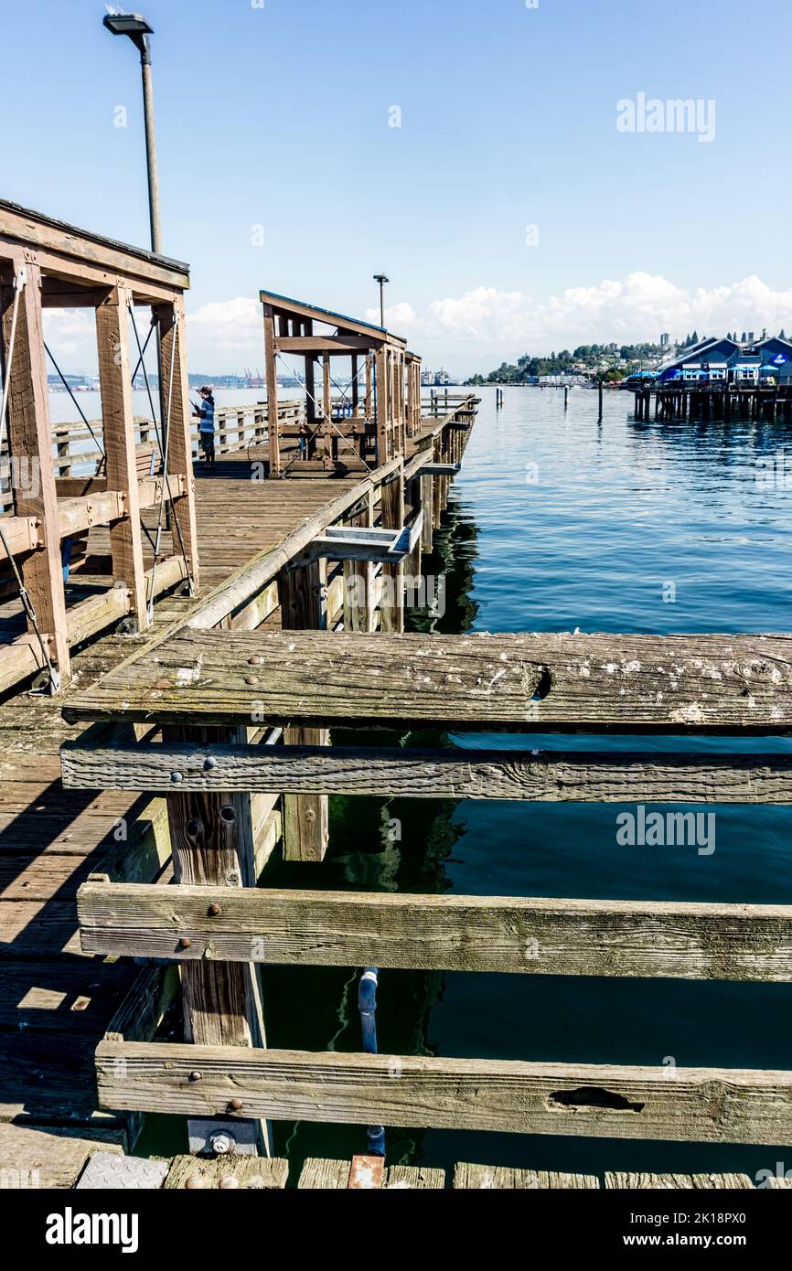 A wooden fish ing pier in Ruston near Tacoma, Washington. Stock Photo