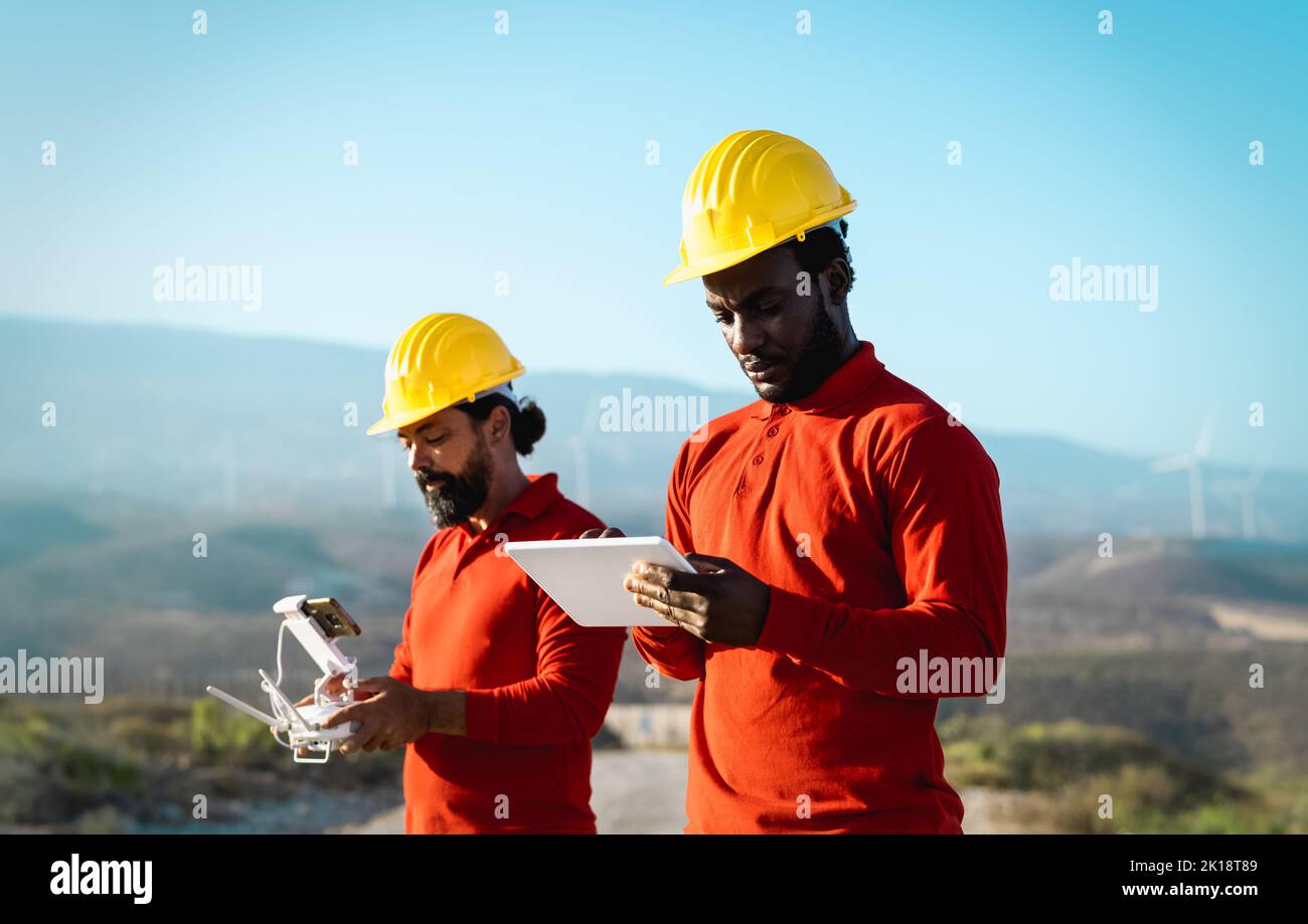 Drone engineers working on wind turbine farm Alternative energy and