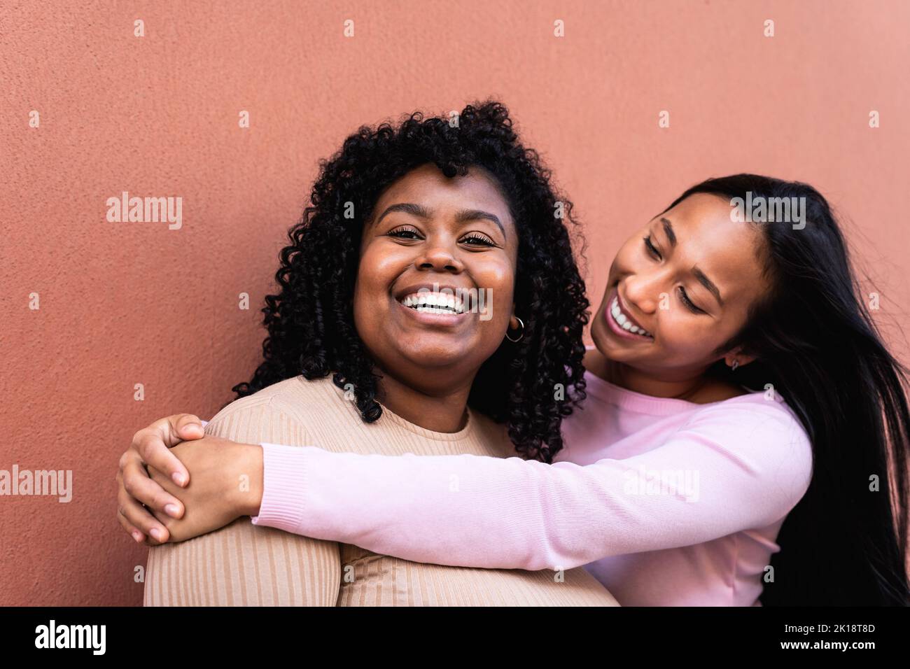 Happy Latin girls having fun embracing outdoor - Young people lifestyle and friendship concept Stock Photo