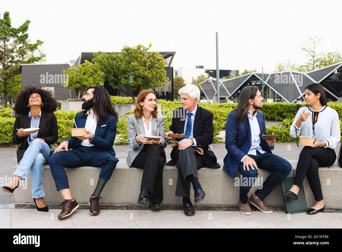 Multiracial business people with different ages having a lunch break outside office Stock Photo