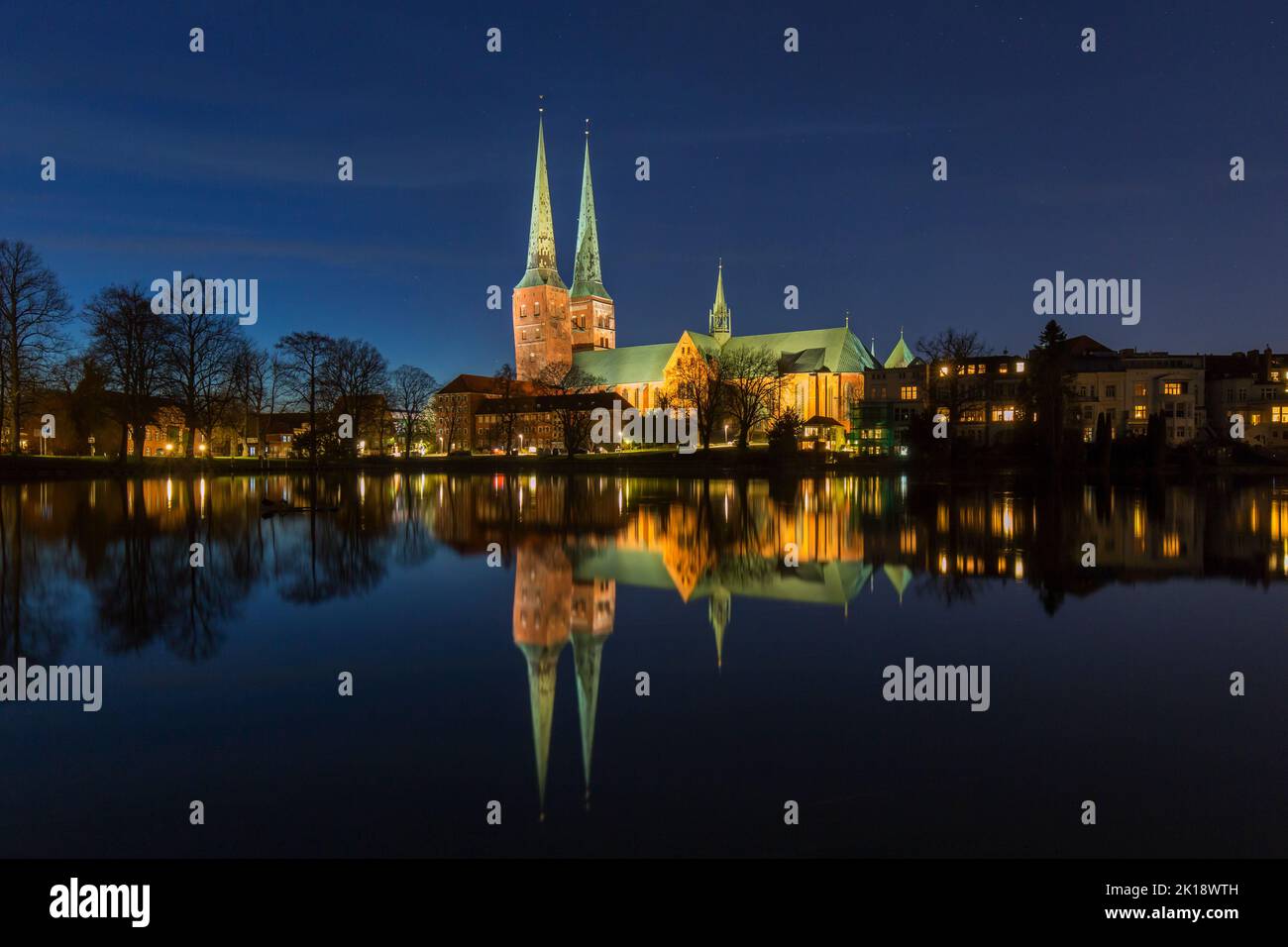 Dom zu Lübeck Cathedral / Lübecker Dom reflected in water of the river Trave at night at the Hanseatic City of Lübeck, Schleswig-Holstein, Germany Stock Photo
