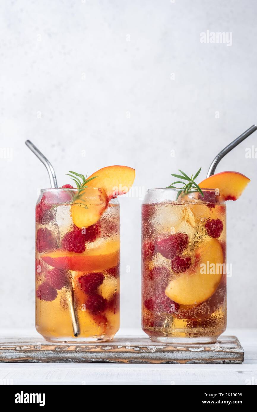 Delicious peach lemonade with soda water and raspberries Stock Photo