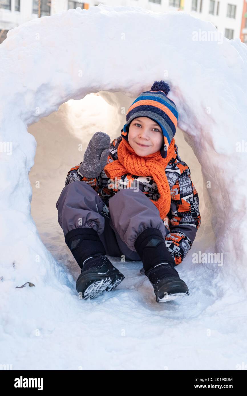 Cute boy playing in the snow castle Stock Photo