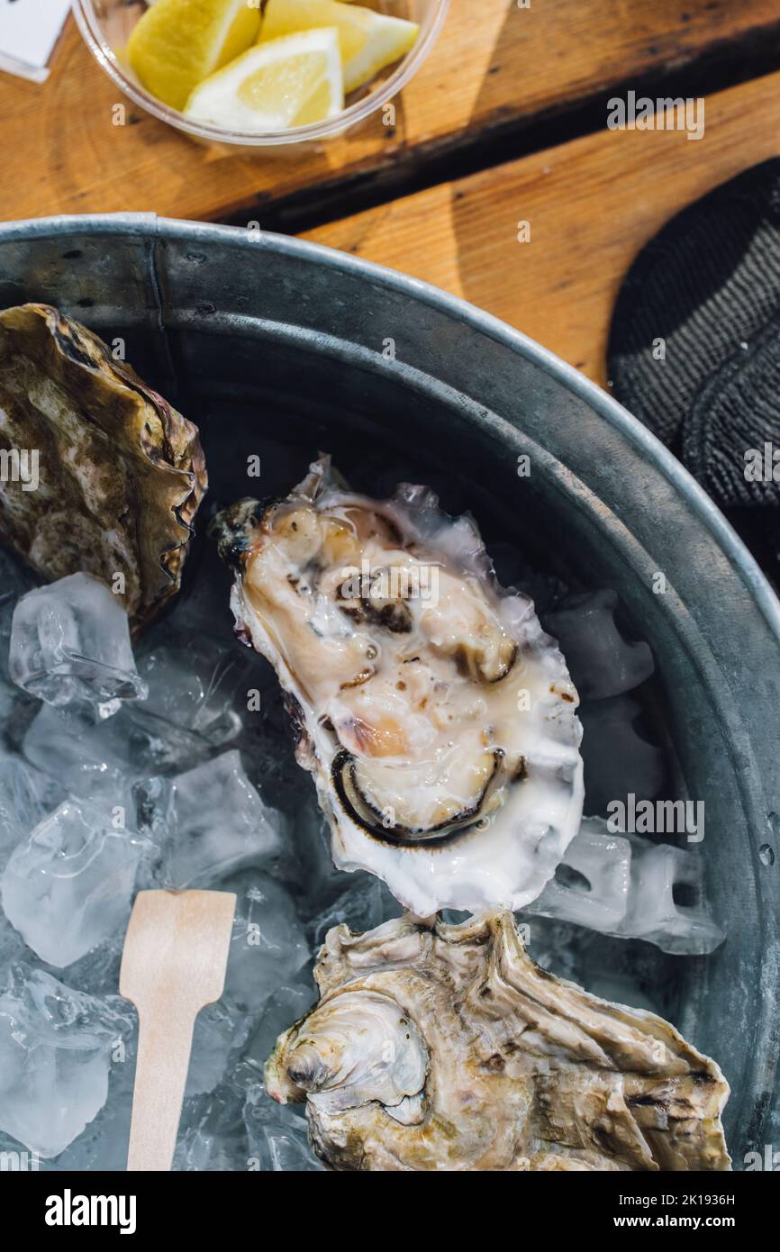 fresh oyster on half shell on ice at seafood restaurant Stock Photo