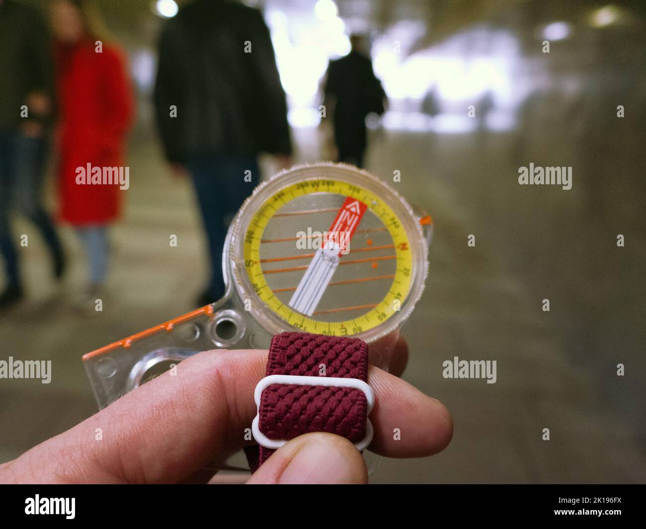 A compass in a person's hand. Orient yourself in the current situation (urban conditions). Follow the innner compass, intuition concept, public sentim Stock Photo