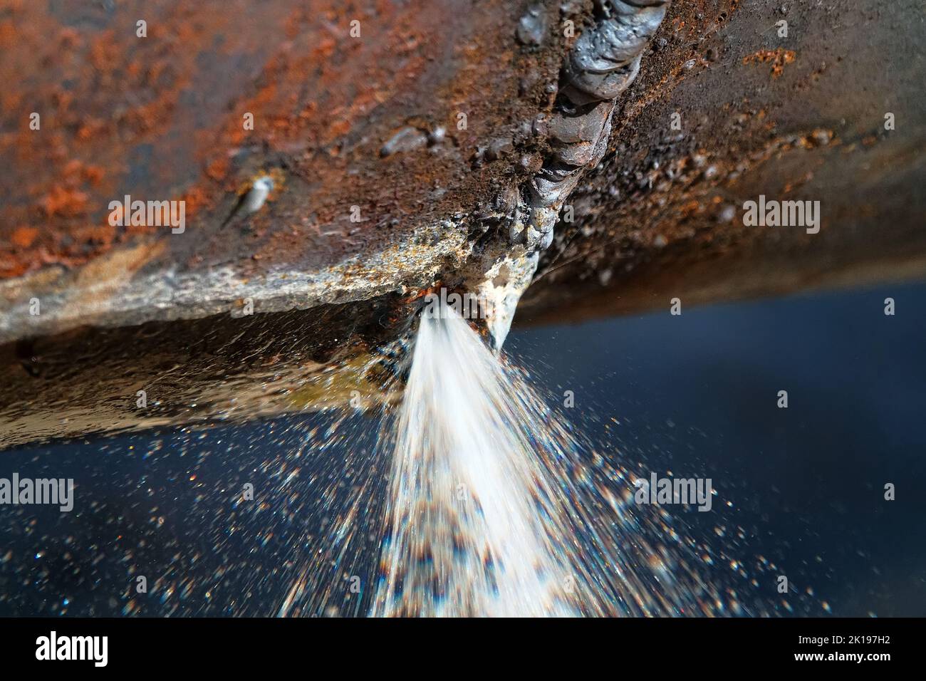 The water broke through an iron water pipe (busted water main). Lack of water saving, loss of drinking water Stock Photo