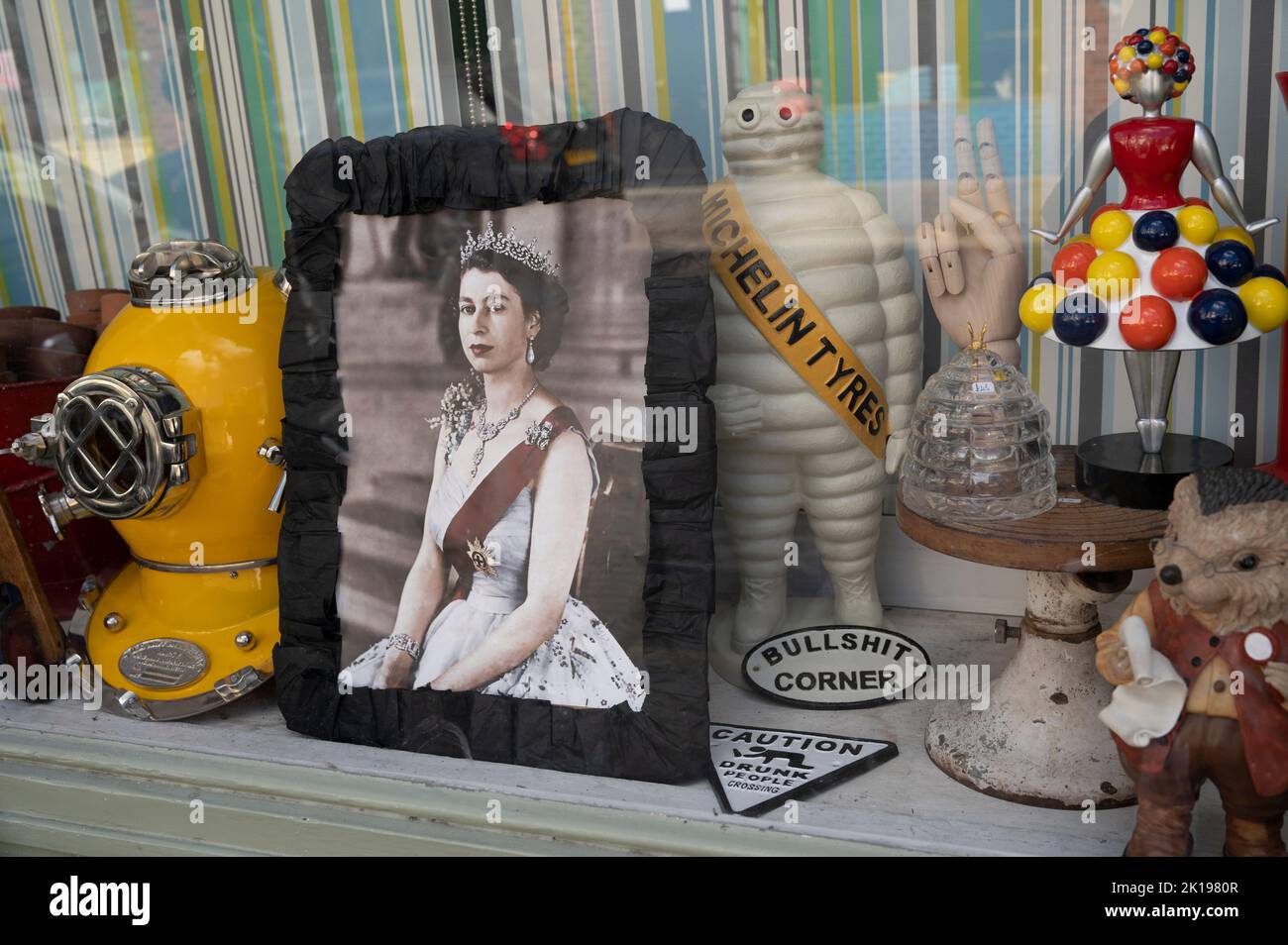 Columbia Road , Tower Hamlets. Window display,  Columbia antiques shop with black border photo of the Queen Stock Photo