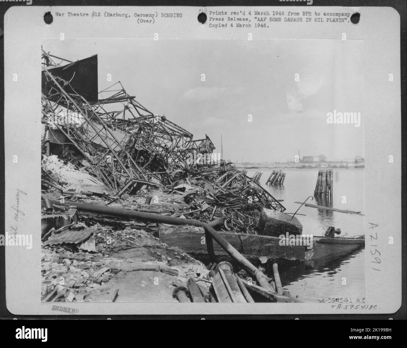 Aaf Bomb Damage In Oil Plants -- Docks And Shore Installations Lie In Tangled Uselessness, The Product Of Aaf Attacks To Throttle German Military Power Thru The Destruction Of The Germany Oil Supply, Production Adn Transportation Facilities. This Maze Of Stock Photo