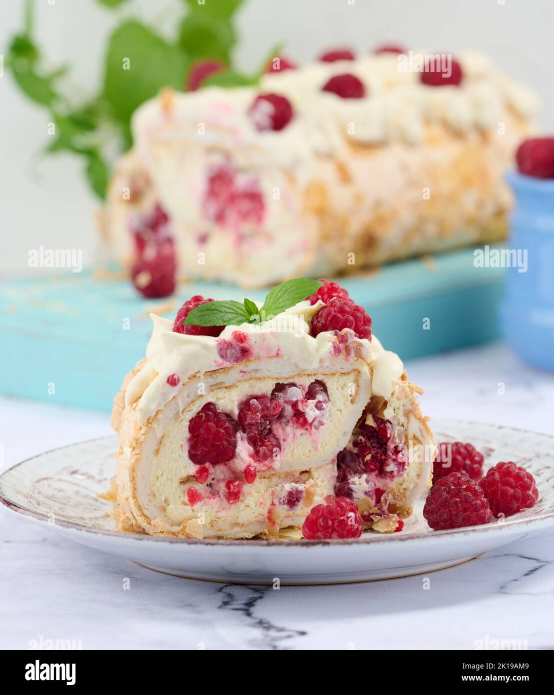 Baked meringue roll with cream and fresh red raspberry, white ...