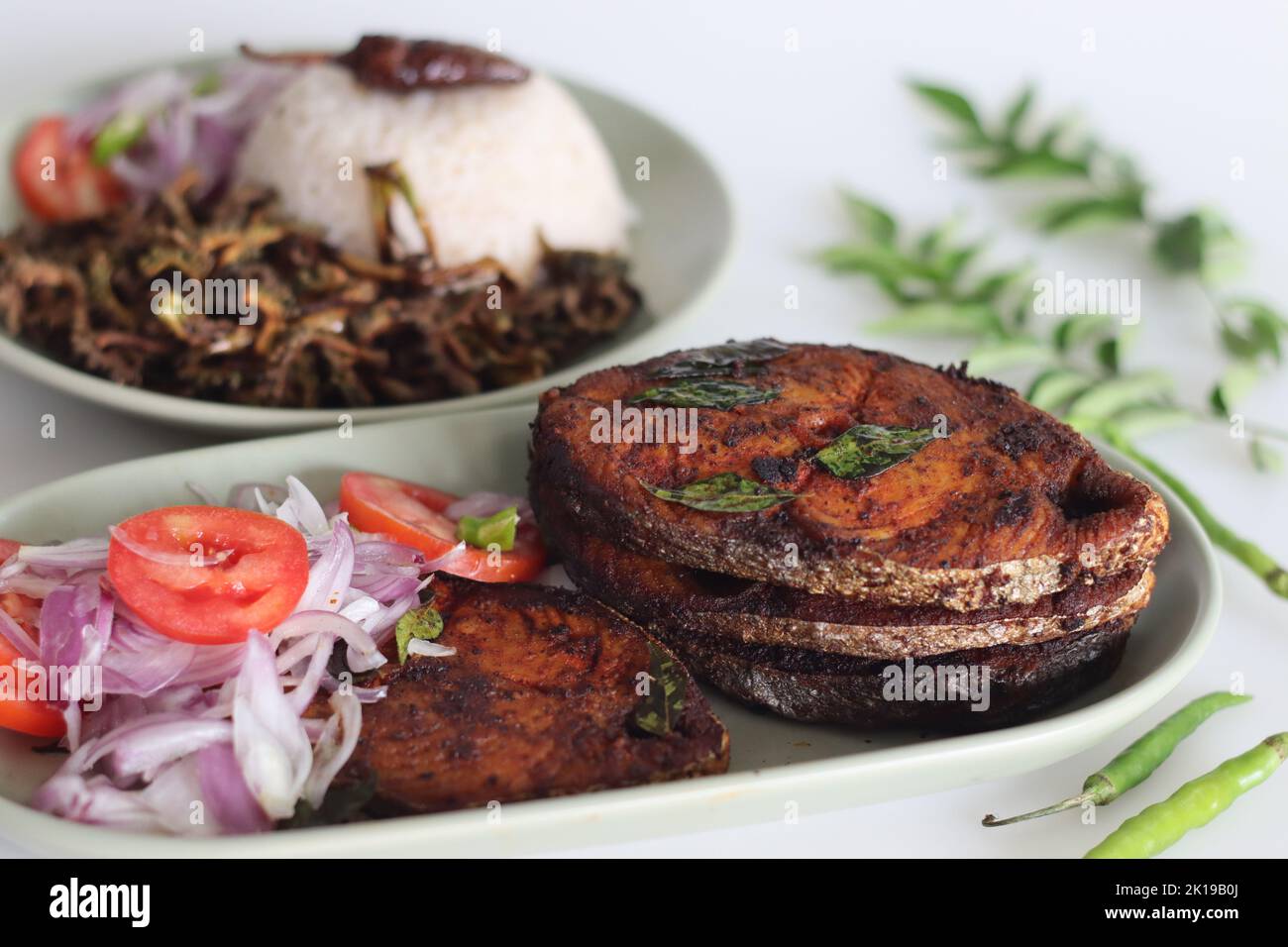 Crispy Surmai fish fry served with white rice meal along with fried ...