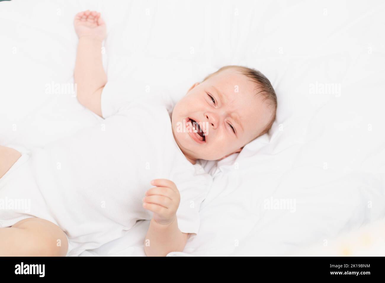 The baby is crying in his crib . The baby 's teeth are teething . Colic