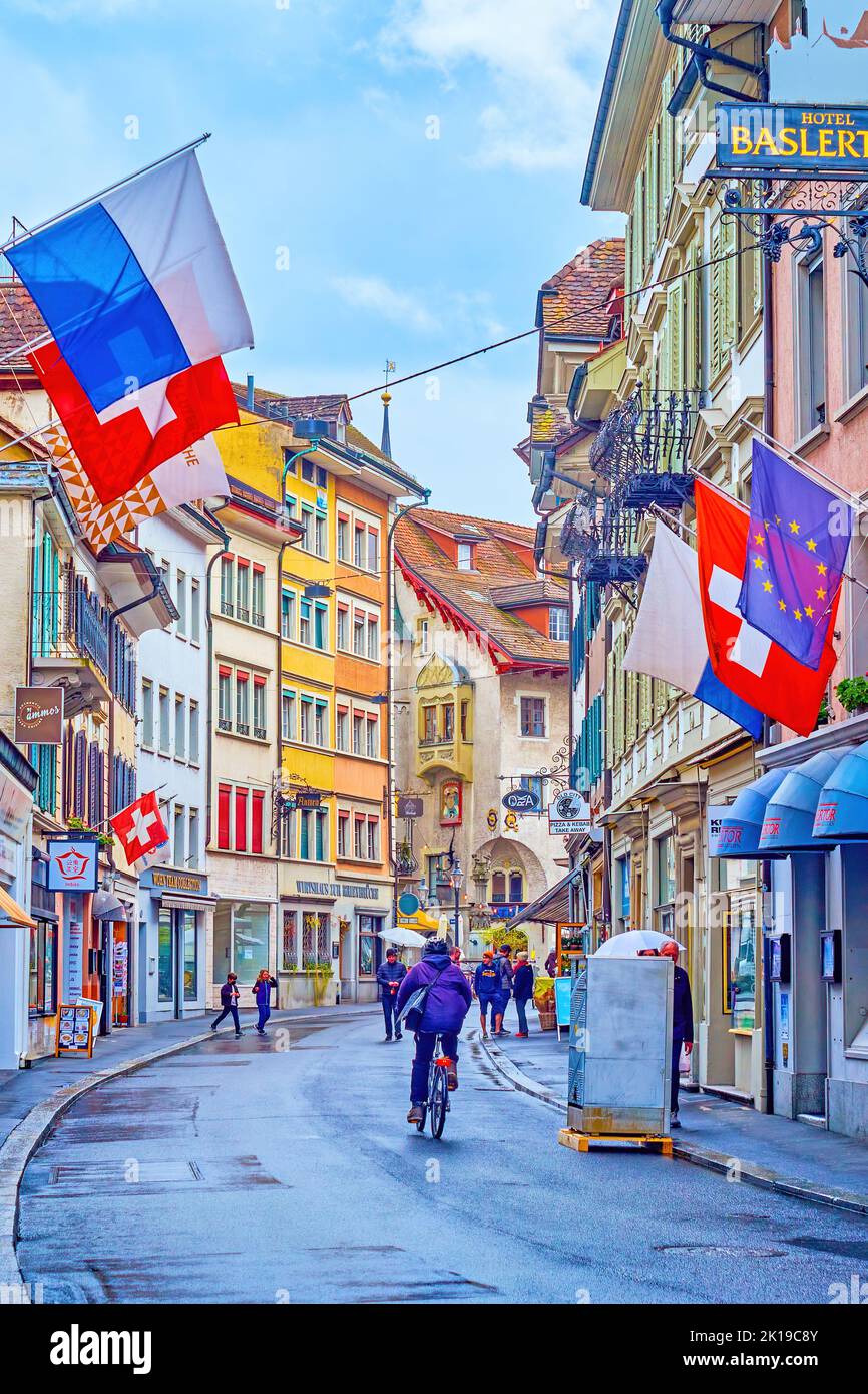 LUCERNE, SWITZERLAND - MARCH 30, 2022: Walk along old curved Pfistergasse street in Altstadt of Lucerne, on March 30 in Lucerne, Switzerland Stock Photo