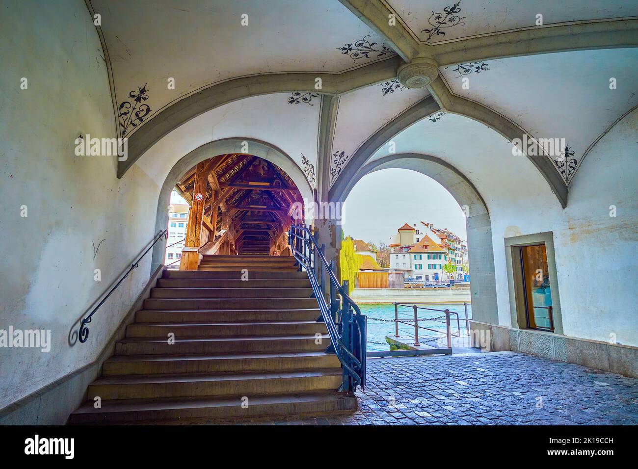 The entrance to medieval Spreuerbrucke bridge from the lower floor of historical building on Pfistergasse street in Lucerne, Switzerland Stock Photo
