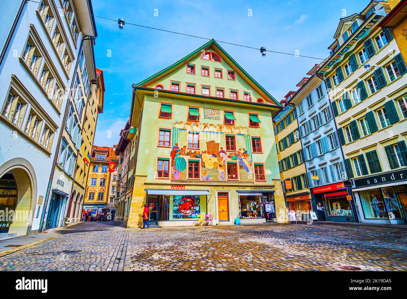 LUCERNE, SWITZERLAND - MARCH 30, 2022: Explore medieval wall art on facades of old houses on Weinmarkt square, on March 30 in Lucerne, Switzerland Stock Photo
