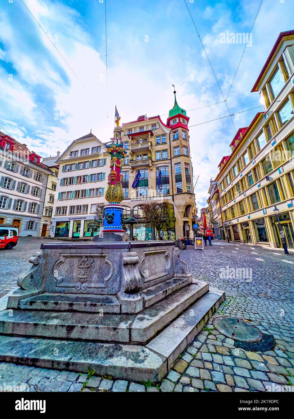LUCERNE, SWITZERLAND - MARCH 30, 2022: Historical colorful Fritschi Fountain in the middle of Kapellplatz, on March 30 in Lucerne, Switzerland Stock Photo
