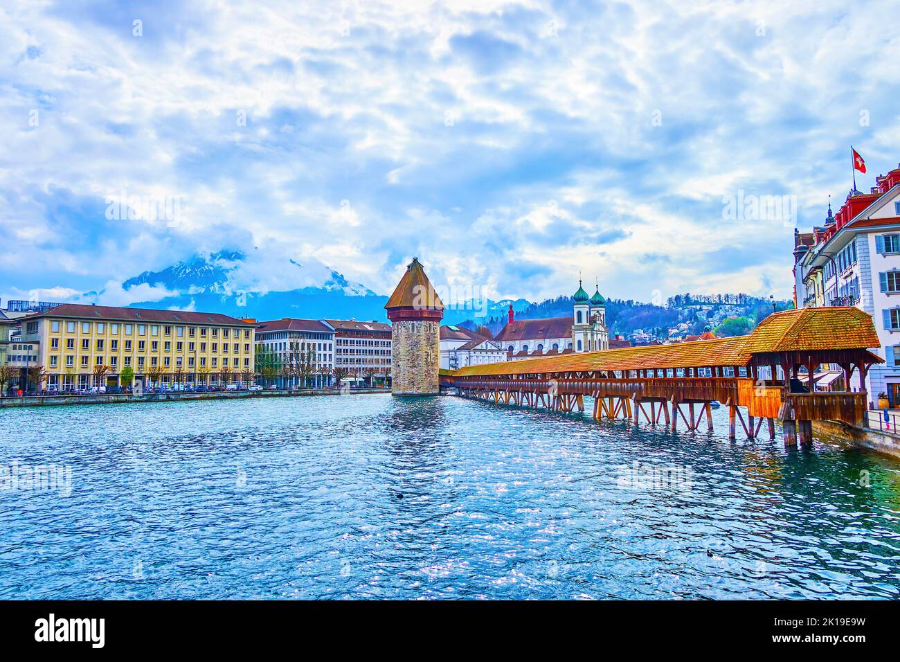 Enjoy magnificent view on medieval symbols of Lucerne, the Kapellbrucke wooden bridge and Wasserturm tower, Switzerland Stock Photo