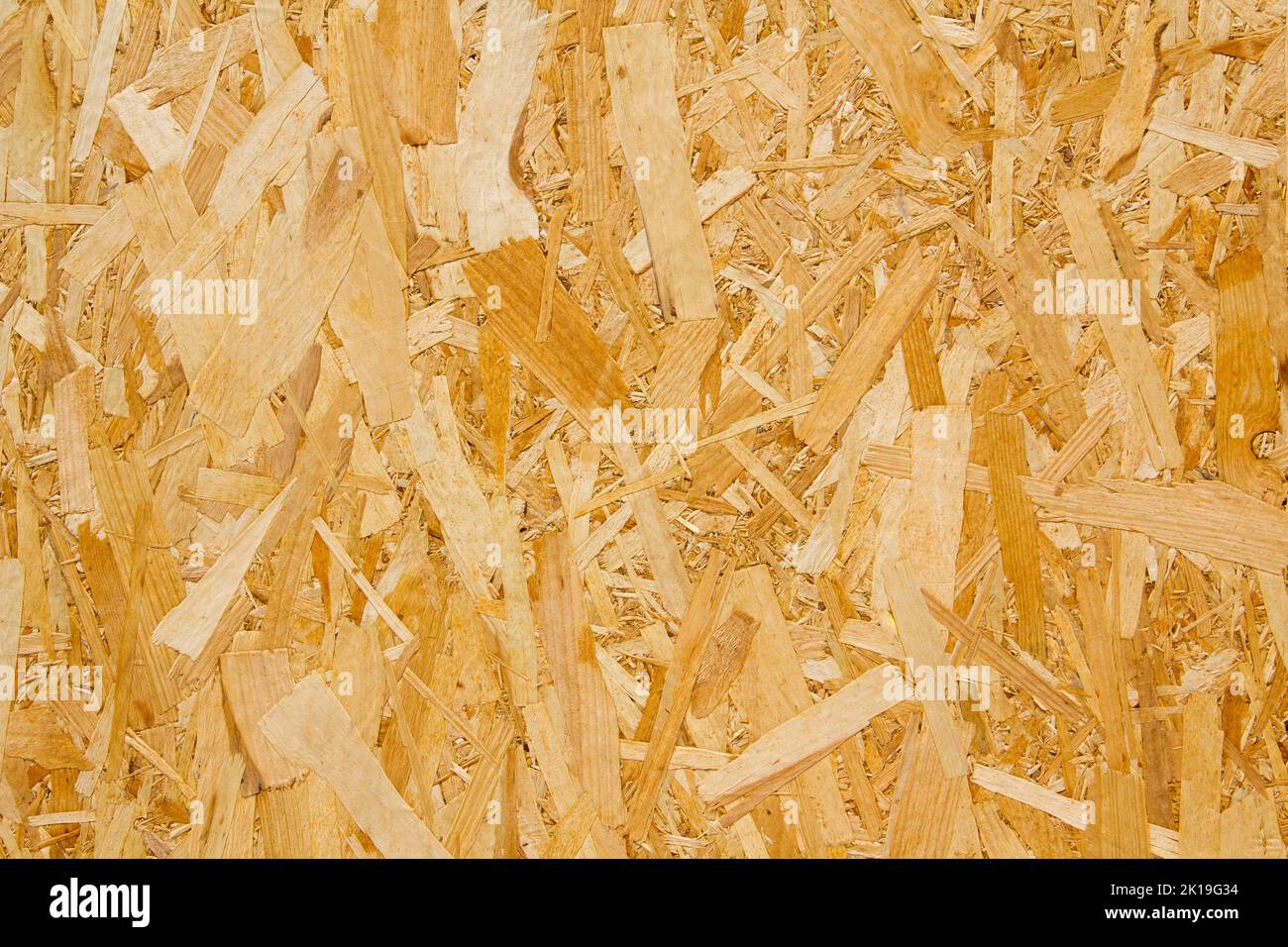 Pressed yellow wood chipboard background pattern texture. Stock Photo
