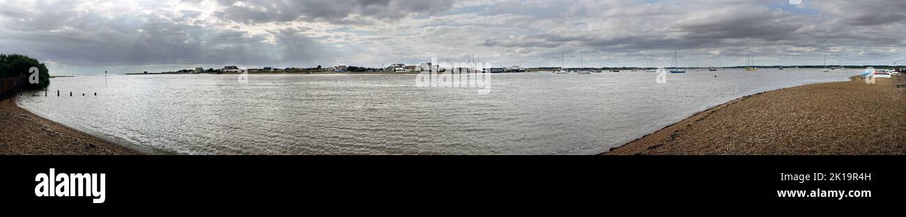 beach at bawdsey suffolk looking  across river deben to felixstowe ferry on dull cloudy day Stock Photo