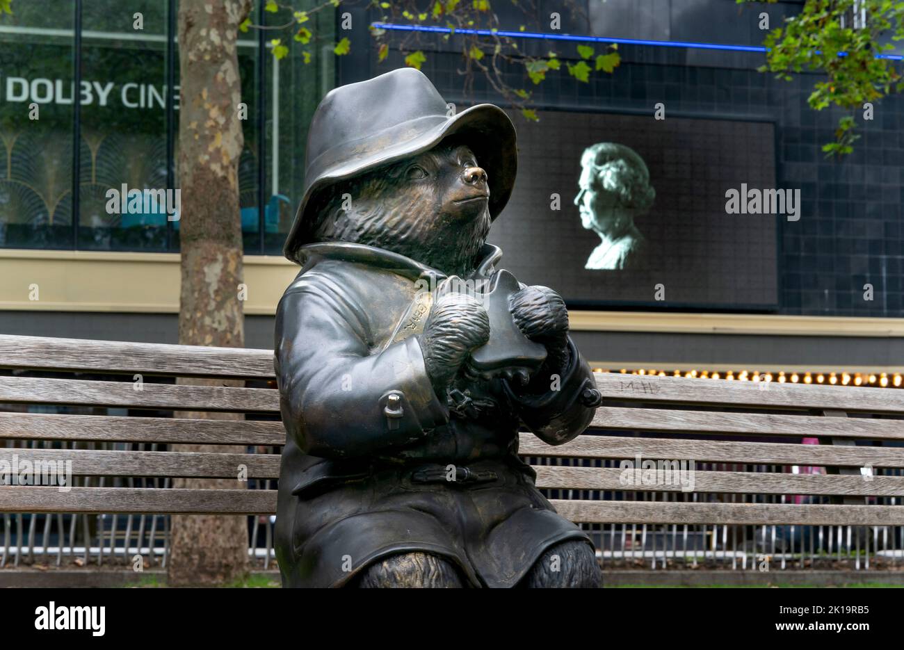 © Jeff Moore  A tribute to the late QUEEN ELIZABETH II at the Odean cinema is seen behind the bronze Paddington Bear statue in London’s Leicester Squa Stock Photo