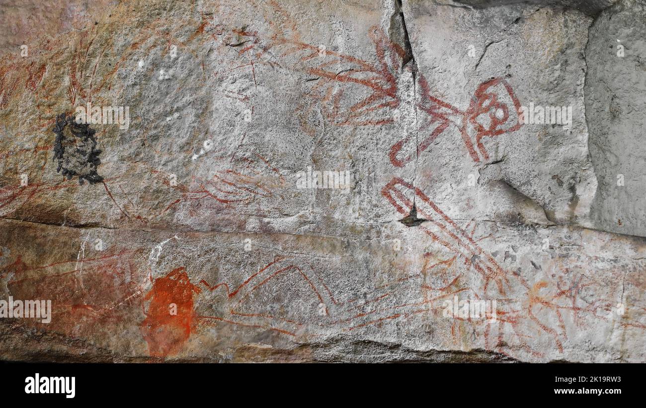 183 Aboriginal rock art. Faded paintings of unknown subjects outlined in red. Ubirr-Kakadu-Australia. Stock Photo