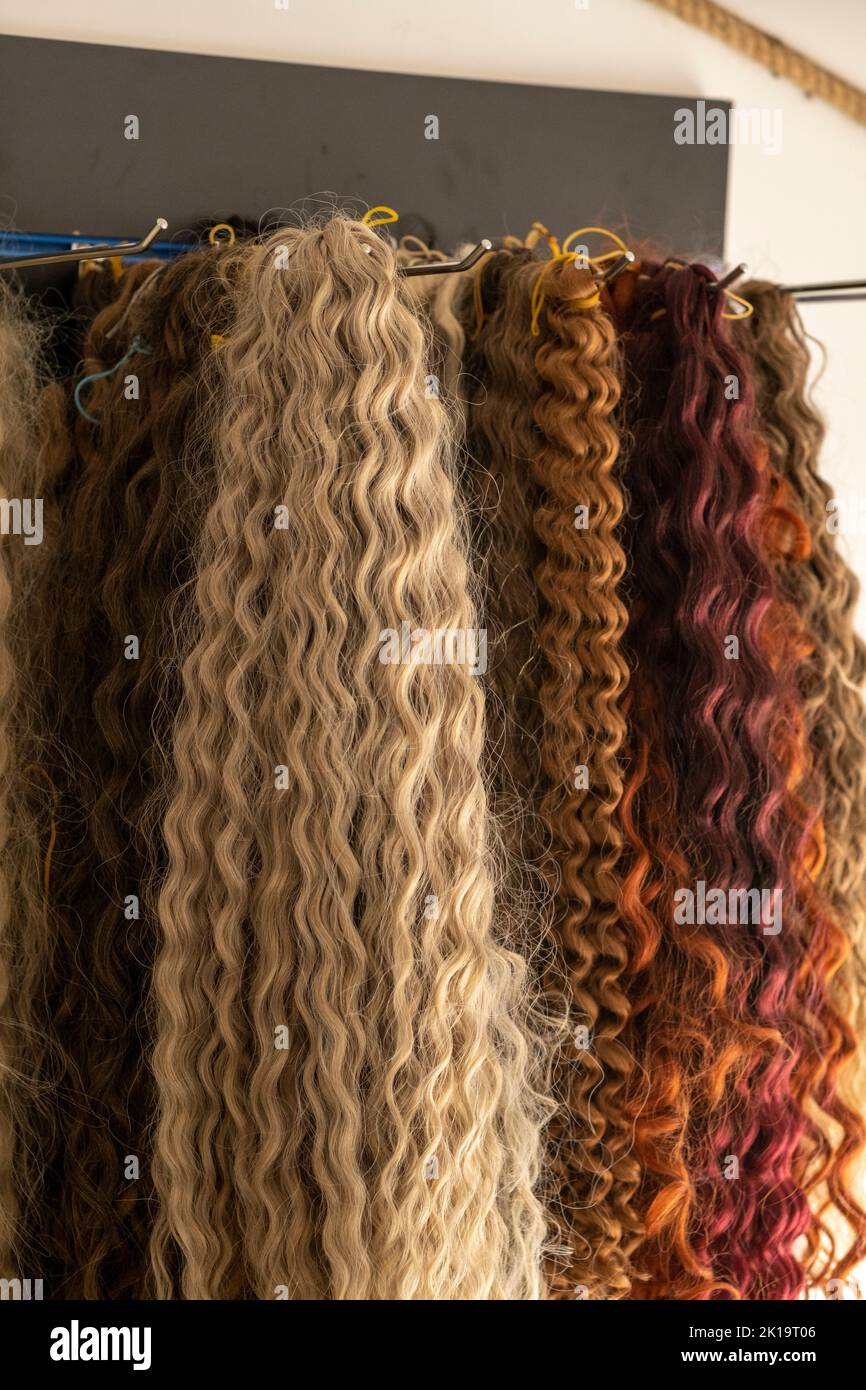 Many varieties of hair for hairstyles. Multicolored hair in beauty salon. Concept of extension, braiding, making hairdo, dreadlocks Stock Photo