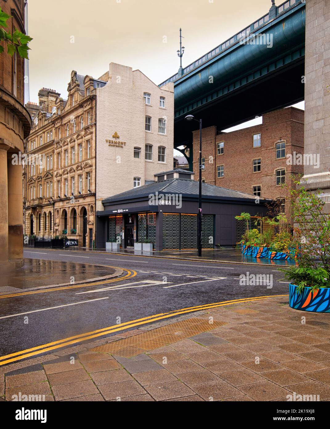 Wet pavement at Newcastle upon Tyme, looking towards the property under the Tyne Bridge Stock Photo