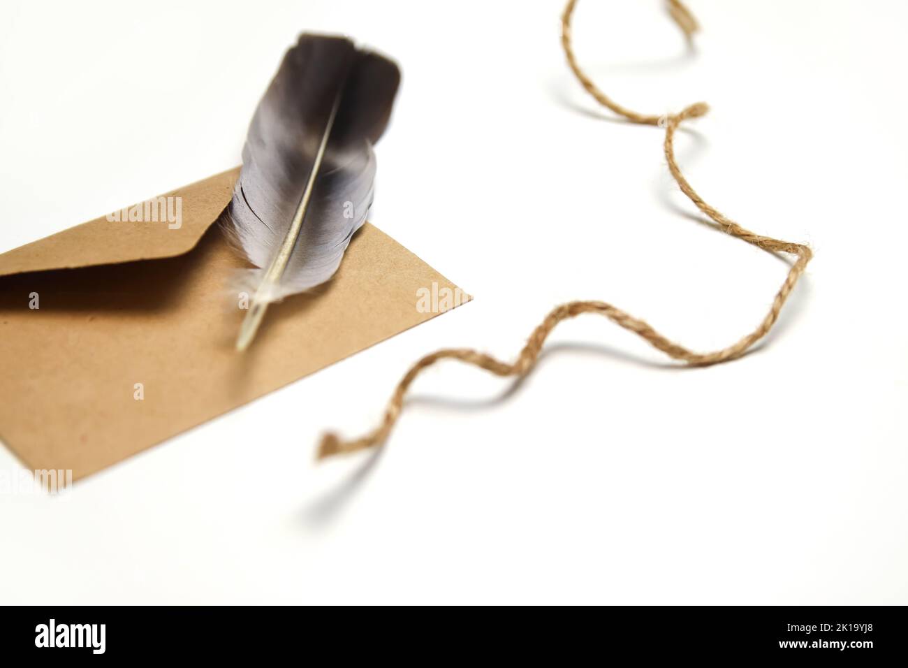 Writing With A Rope Pen Craft eco rope and envelope, feather pen on white background. Christmas ...
