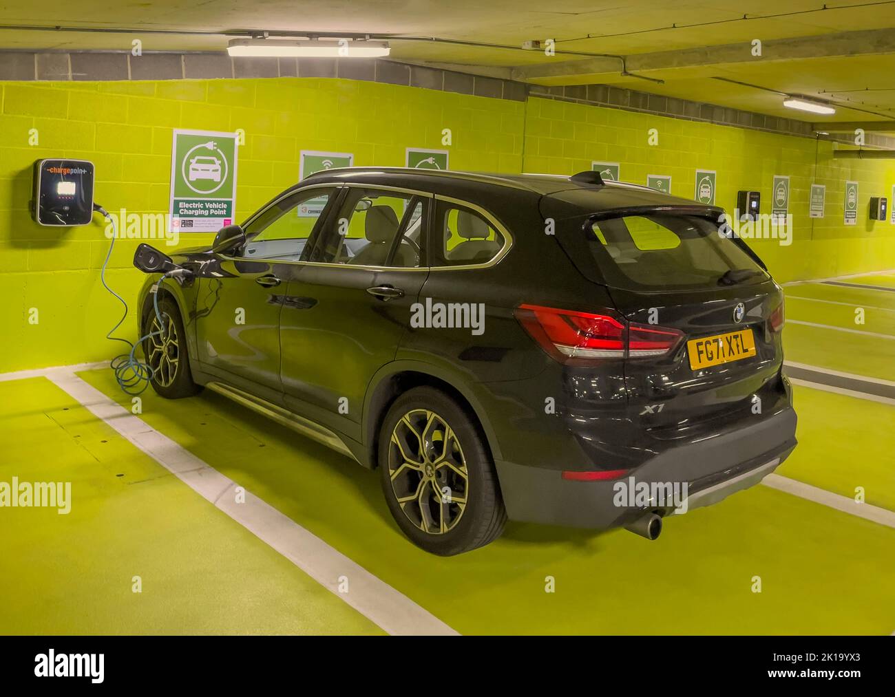 Newbury, Berkshire, England, UK. 2022. Electric car battery charging station in an underground car park. Stock Photo